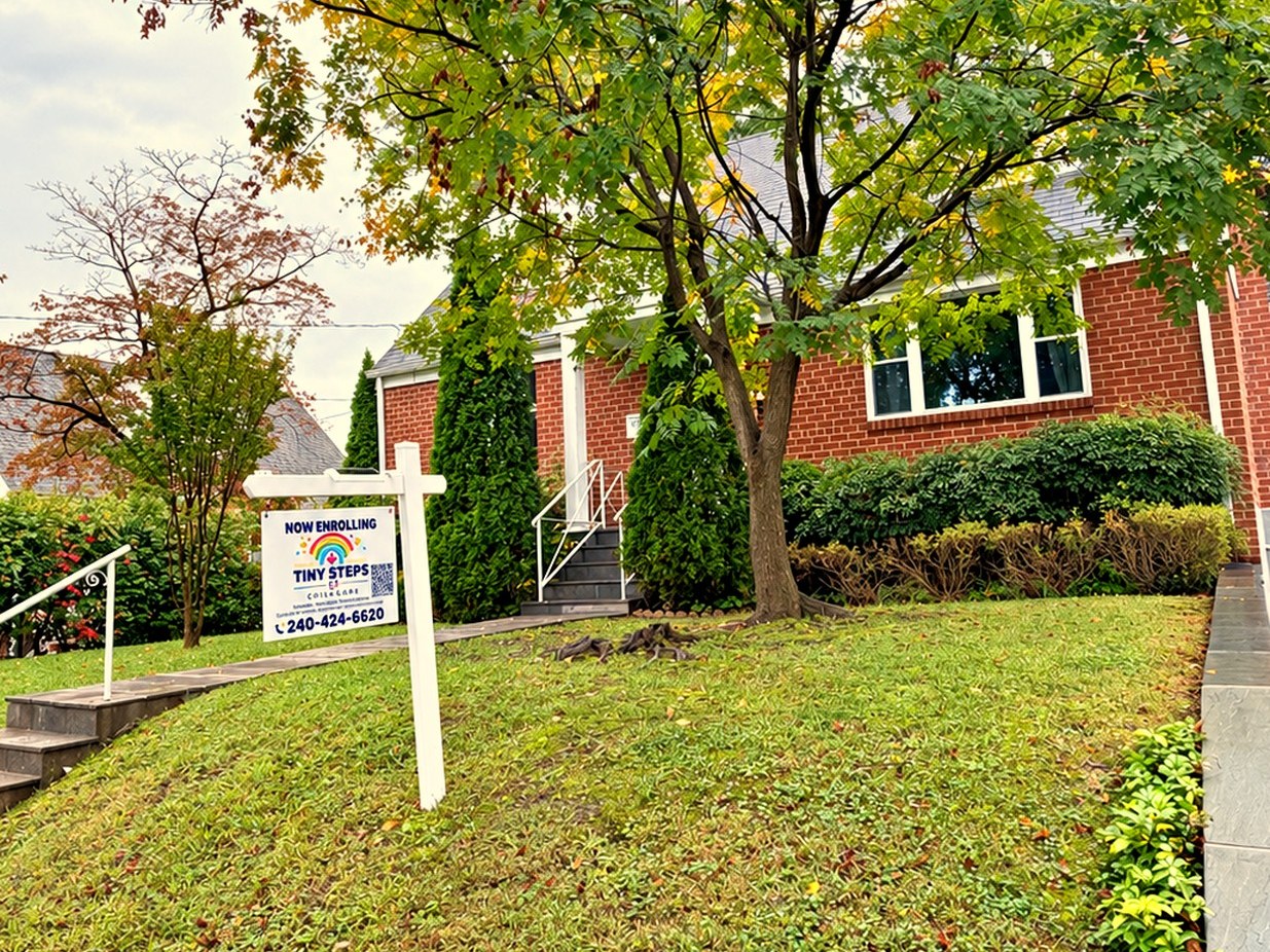 Front exterior of Tiny Steps Child Care at 12702 Bluhill Road with NOW ENROLLING yard sign