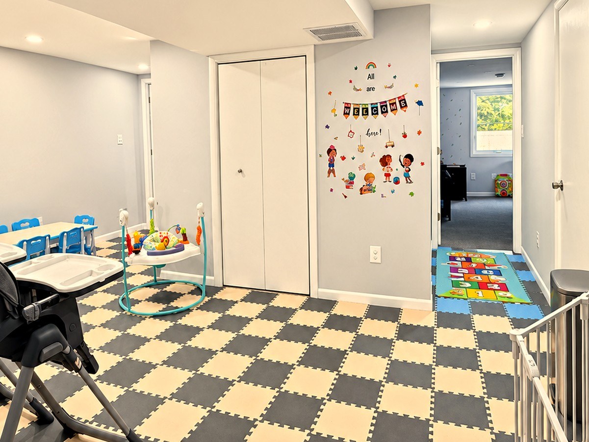 Child dining and play area with foam mats, high chair, and small table